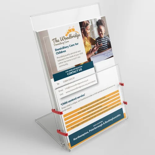 A Woodbridge Domiciliary Care leaflet, headed Domiciliary Care for Children, standing in an acrylic display stand
